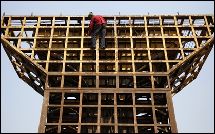 A labourer climbs down from an under-construction pillar of a flyover bridge in Mumbai.