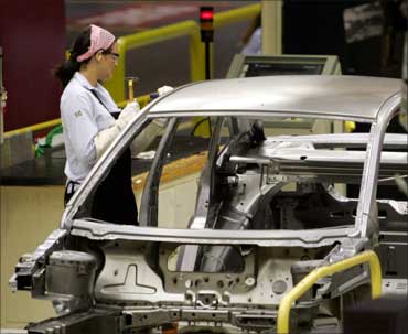 A Ford Motor Company worker works on the assembly line of the Ford Fiesta.