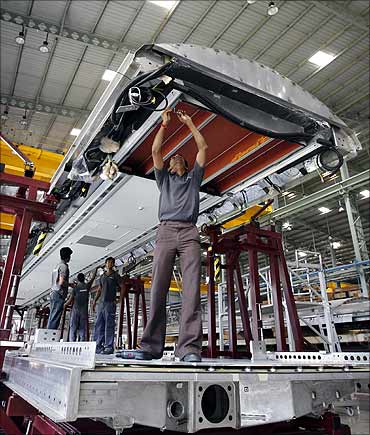 Employees assemble a coach inside private railway equipment production unit of Bombardier at Savli.