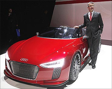 Audi AG Chairman Rupert Stadler poses with the Audi e-tron Spyder concept car at CES, Las Vegas.