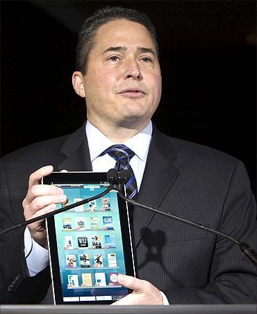 Bob Scaglione, chief marketing officer for Sharp Electronics USA, holds a Galapagos e-Media Tablet.