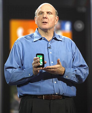 Microsoft CEO Steve Ballmer holds a Windows 7 phone.