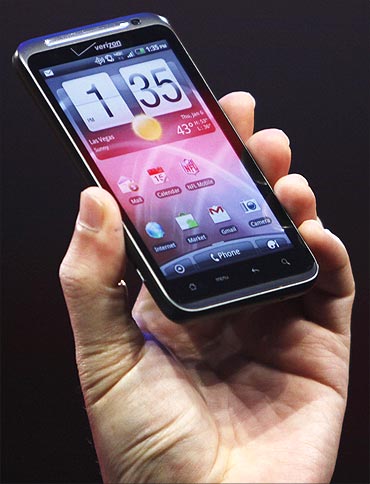 HTC CEO Peter Chou holds a HTC Thunderbolt 4G Verizon smartphone.