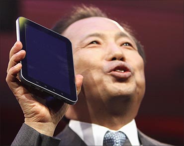 JK Shin, president Samsung's mobile communications business, holds up a new 4G Galaxy Tablet.