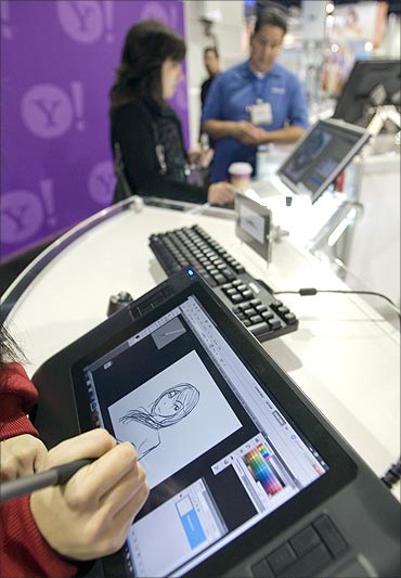 A visitor tries out a Wacom Bamboo Pen and Touch tablet during the 2011 International Consumer Electronics Show (CES) in Las Vegas.