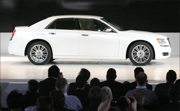 A Chrysler 300 is driven on to the stage at the North American International Auto show in Detroit.