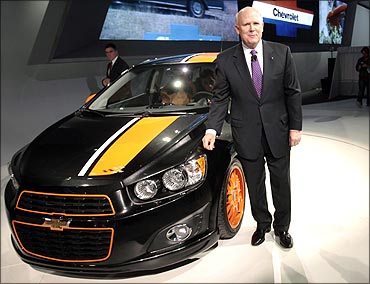 General Motors Chairman and CEO Dan Akerson stands next to the 2011 Chevrolet Sonic Z-spec concept v