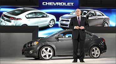 General Motors Chairman and Chief Executive Dan Akerson stands in front of the 2012 Chevrolet.