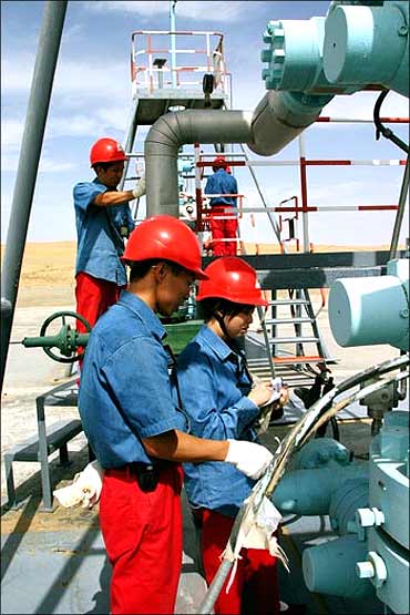 Chinese employees of China National Petroleum Corp work at Tarim Oil Field.