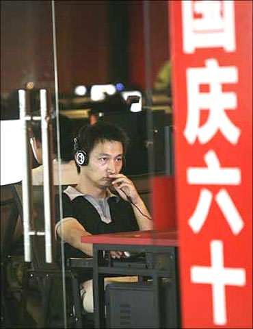 A man uses a computer at an internet cafe in Beijing.