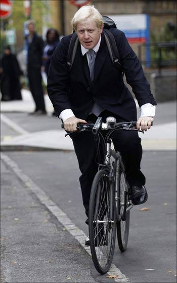 The Mayor of London Boris Johnson cycles back to his office from a health centre in west London.