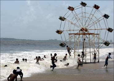 A slightly submerged Ferris wheel at a beach in Mumbai.