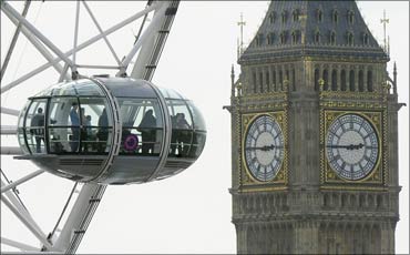 Visitors look out from a pod on the London Eye towards Big Ben and the Parliament in London.