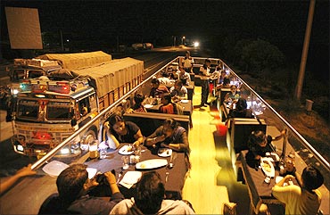 People dine on a double-decker bus which has been converted to a mobile restaurant.