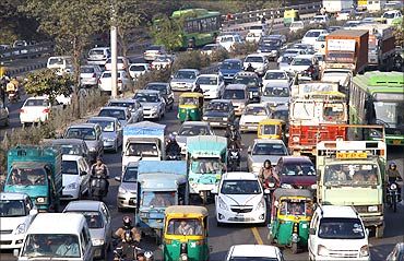 Traffic moves along a busy road in New Delhi.