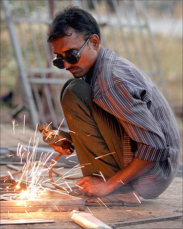 A welder works at a workshop.