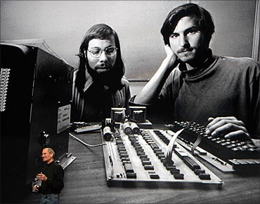 Steve Jobs stands under a photo of him and Apple-co founder Steve Wozniak, January 27, 2010.