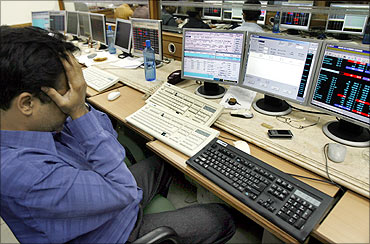 A broker reacts while trading at a stock brokerage firm in Mumbai.