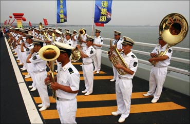 A band plays during the opening ceremony of the Qingdao Jiaozhou Bay Bridge in Qingdao.