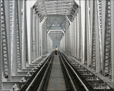 A man crosses a railway bridge on Teesta River near Siliguri