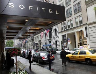 People pass by the Sofitel hotel after Strauss-Kahn was arrested and charged with sexual assault.