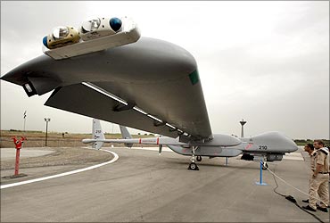 Israeli soldiers look at an IAI Eitan, also known as the Heron TP, surveillance unmanned air vehicle