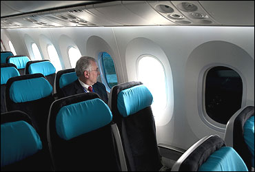 A Boeing employee sits next to a tinted window on the Boeing 787 Dreamliner at Farnborough airport.