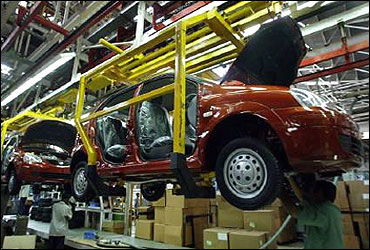 Engineers work on a car body at Tata Motors Ltd in Pune.