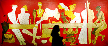 A visitor looks at a painting by M F Husain.