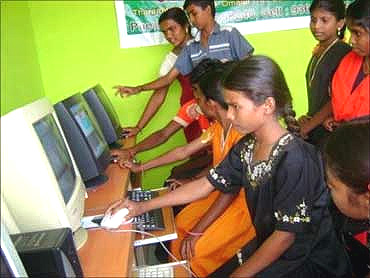 Village children attend a computer class.