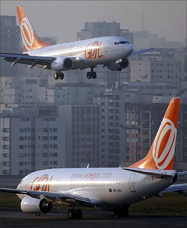 A Brazilian airline Gol aircraft (top) prepares to land at Congonhas airport in Sao Paulo.