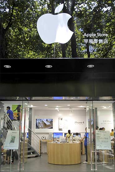 Customers and employees are seen in a fake Apple store in Kunming.