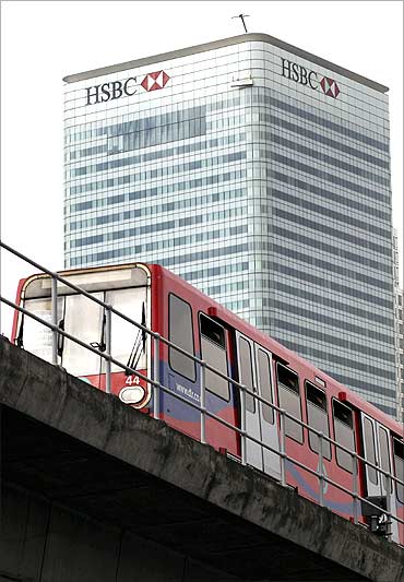 A commuter train passes the HSBC building on Canary Wharf in London.