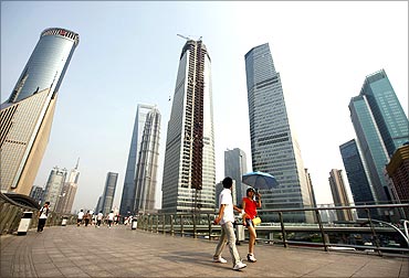 Visitors walk through the Lujiazui Financial Area in Shanghai.