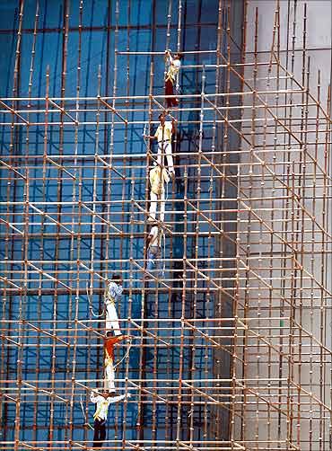 Men work at the construction site of a commercial complex in New Delhi.