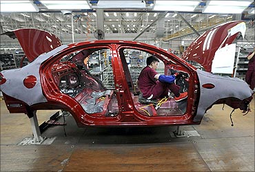 An employee assembles a car at the production line of Anhui Jianghuai Automobile Co in Hefei.