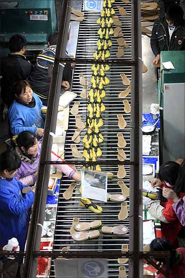 Workers make shoes, to be exported to the US.