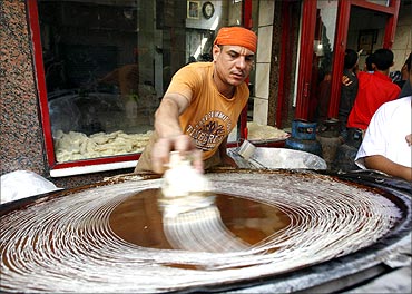 An Egyptian man prepares kunafa, a traditional Middle Eastern dessert, on the first day of Ramadan in Cairo.