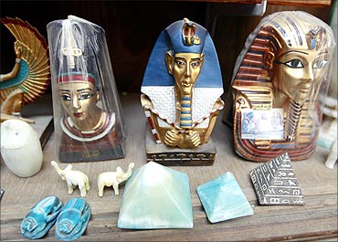 Souvenirs wrapped in plastic sit on a shelf at a tourist store in the Khan al-Khalili area of Cairo.