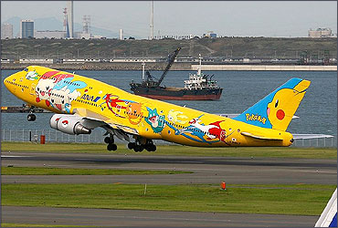 An ANA Boeing 747-400 in a Pokemon livery takes off from Tokyo International Airport.