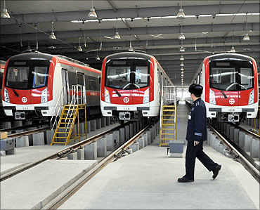 A driver walks in front of trains after testing a train at a metro station in Shenyang.