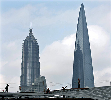 Migrant labourers work at a construction site in downtown Shanghai.