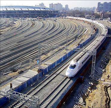 A bullet train departs from the under-construction Beijing South Railway Station.