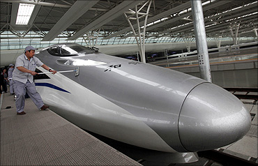 Workers clean the exterior of a CRH 380A bullet train.