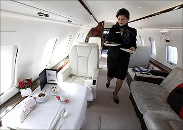A Vistajet flight attendant prepares a breakfast in a Bombardier 605 aircraft in Geneva.