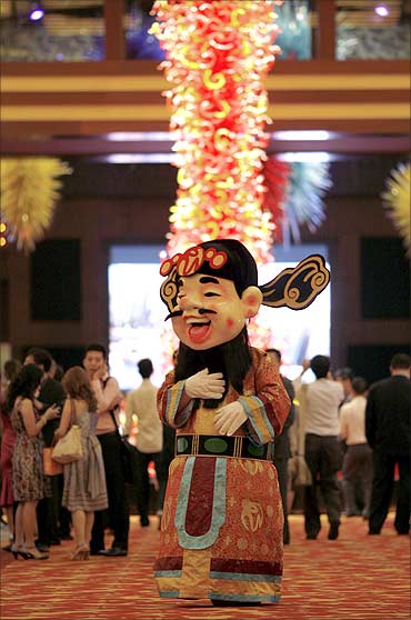A man dressed as a Chinese God of Fortune walks inside the Resorts World Sentosa casino.