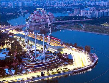 An aerial view at dusk shows part of the illuminated Marina Bay street circuit of the Singapore.