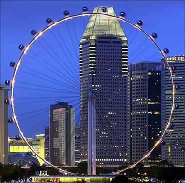 The Singapore Flyer observation wheel is pictured at dusk.