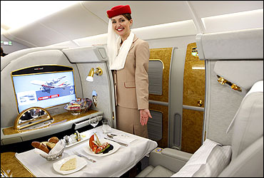 A flight attendant poses in the first class section of Emirates' Airbus A380.