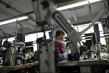 A labourer works at a shoe factory in the city of Wenzhou, in Zhejiang.